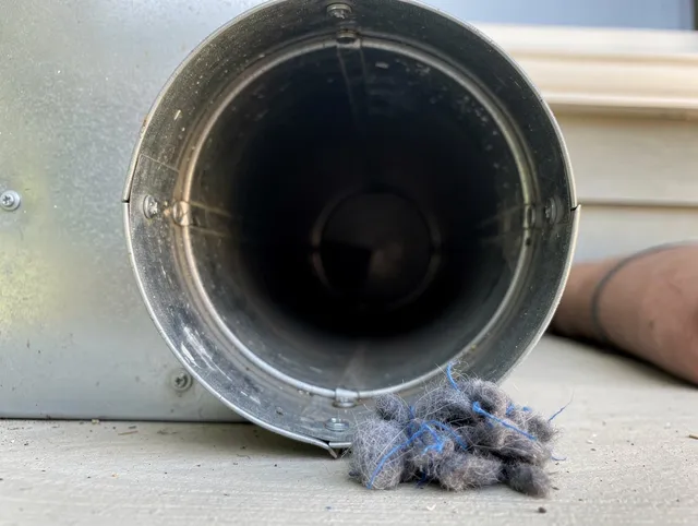Belmont Dryer Vent Cleaning technician using specialized equipment to clear severe dryer vent blockage in Belmont